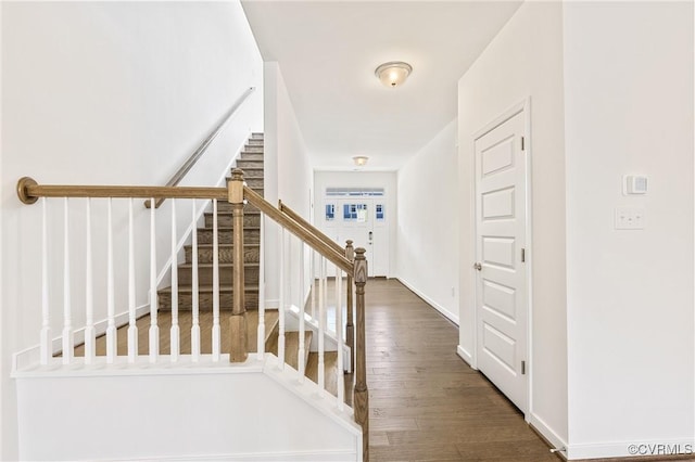 interior space featuring stairway, wood finished floors, and baseboards