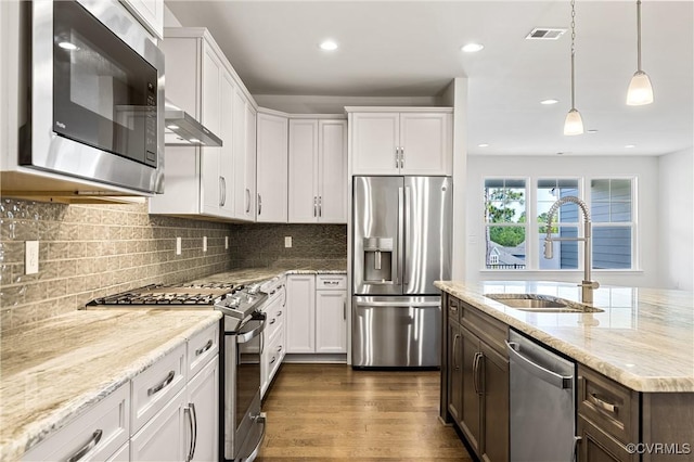 kitchen featuring dark wood finished floors, white cabinetry, appliances with stainless steel finishes, and a sink