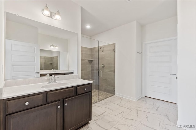 bathroom featuring baseboards, vanity, marble finish floor, and a shower stall