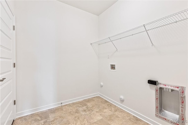 clothes washing area with laundry area, hookup for a washing machine, gas dryer hookup, and baseboards