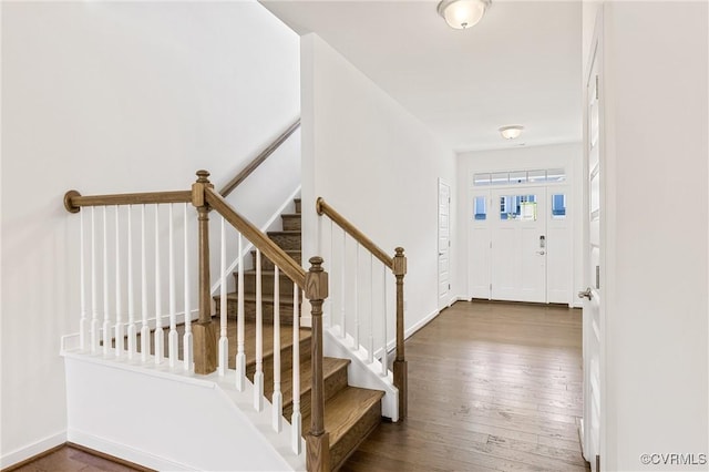 entrance foyer featuring stairway, baseboards, and wood-type flooring