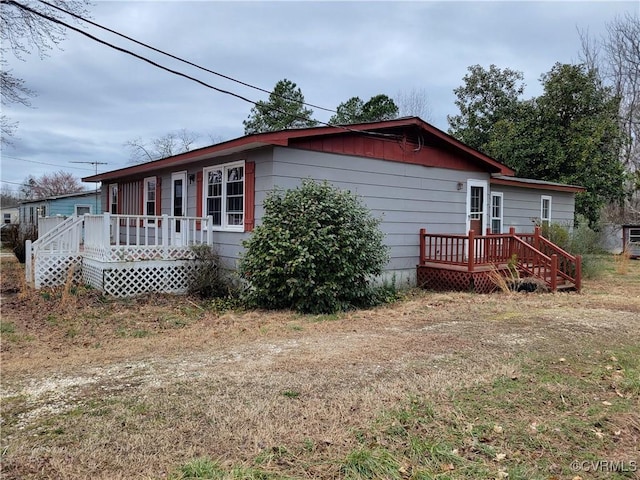 view of home's exterior with a wooden deck