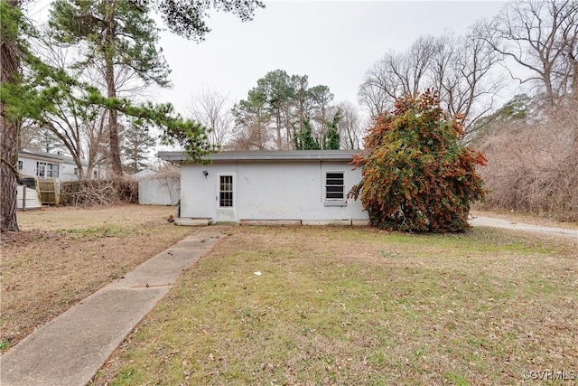 back of house with a lawn