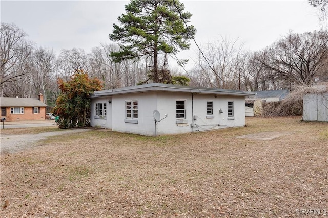 back of house featuring a lawn