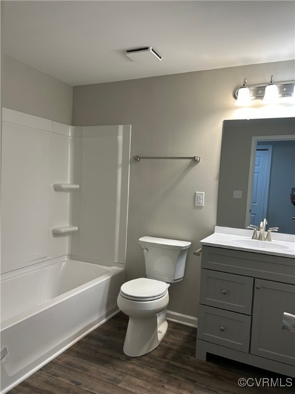 bathroom featuring visible vents, toilet, shower / tub combination, wood finished floors, and vanity