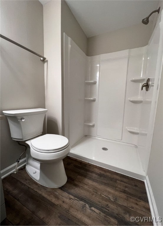 full bath with a shower, baseboards, toilet, and wood finished floors