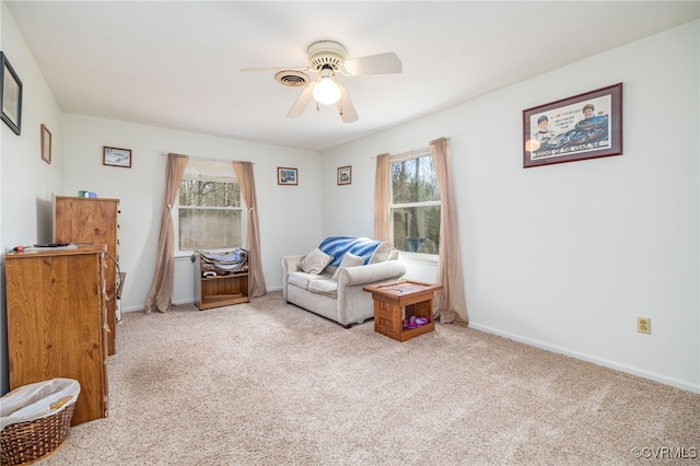 sitting room featuring carpet flooring, baseboards, and ceiling fan