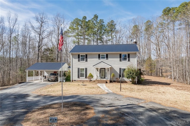 view of front of home with aphalt driveway, crawl space, and metal roof