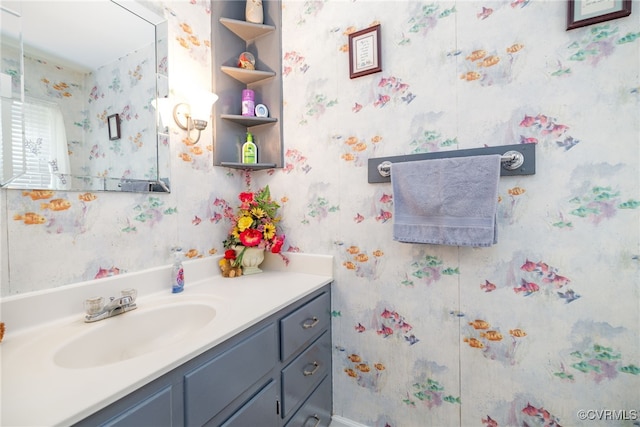 bathroom featuring vanity and wallpapered walls