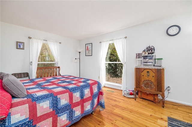 bedroom featuring visible vents and wood finished floors