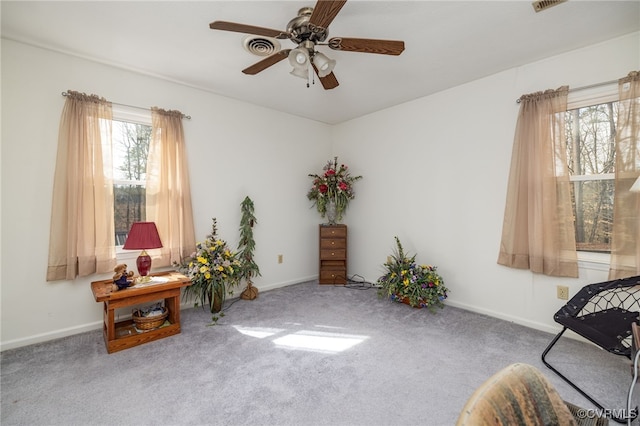 sitting room featuring baseboards, carpet, and ceiling fan