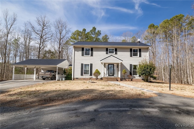 colonial inspired home with crawl space, metal roof, and driveway