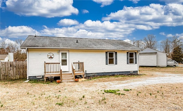 rear view of property featuring a deck, fence, roof with shingles, and crawl space