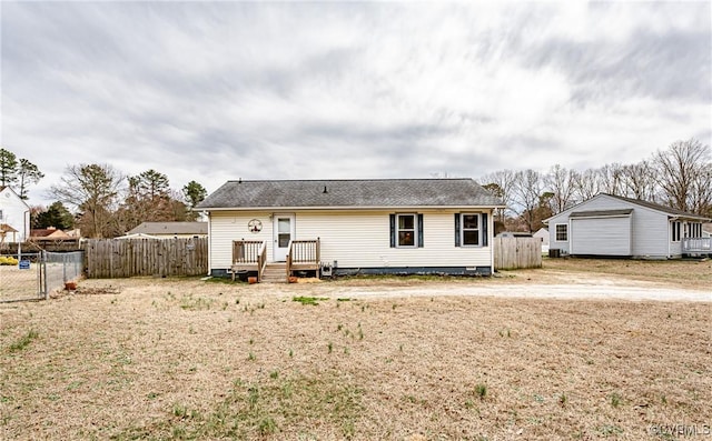 view of front of house with crawl space, a wooden deck, and fence