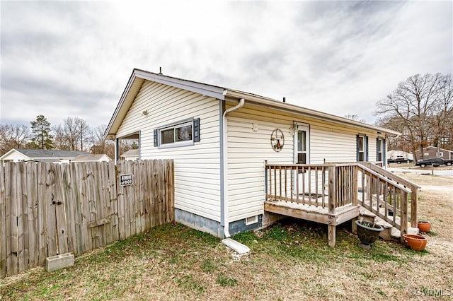 exterior space with fence and a wooden deck