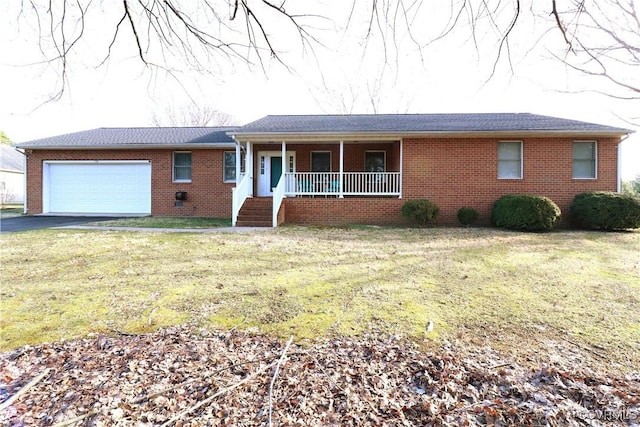 ranch-style home with brick siding, an attached garage, a front lawn, covered porch, and driveway