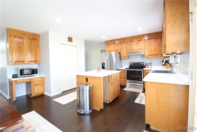 kitchen featuring a sink, light countertops, under cabinet range hood, appliances with stainless steel finishes, and a center island