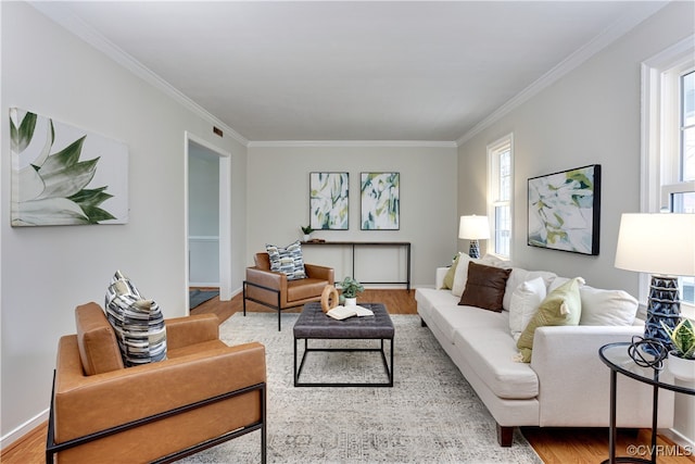 living room featuring baseboards, wood finished floors, and crown molding