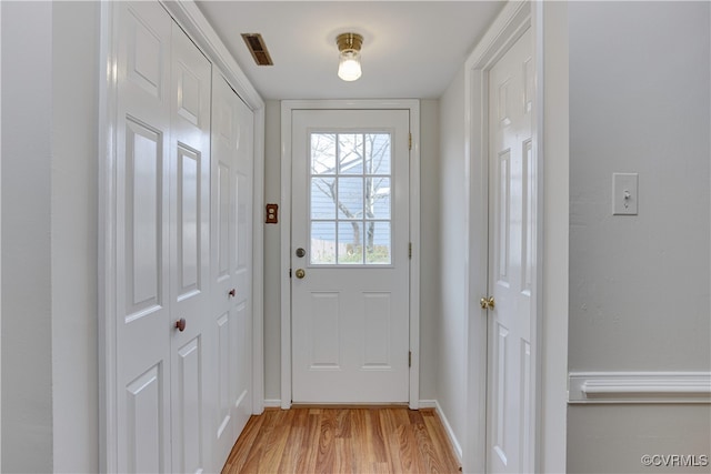 doorway to outside with visible vents and light wood-style flooring