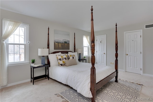 carpeted bedroom with visible vents and baseboards