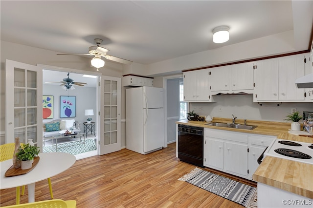 kitchen featuring light wood-style flooring, freestanding refrigerator, a sink, french doors, and dishwasher