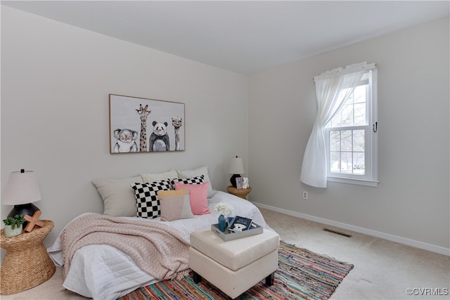 carpeted bedroom with visible vents and baseboards