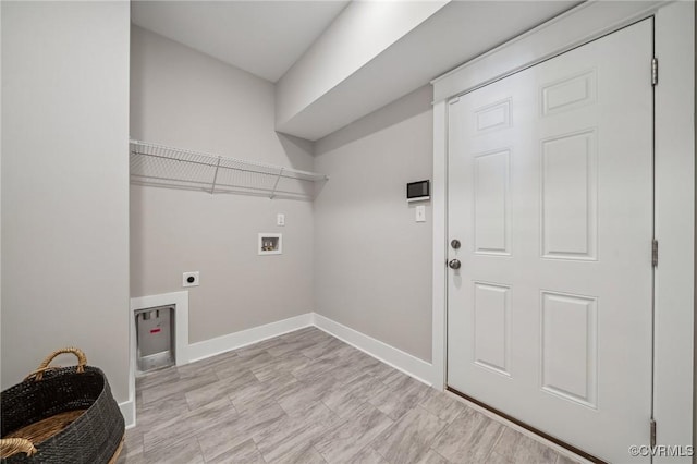 clothes washing area with washer hookup, laundry area, baseboards, and electric dryer hookup