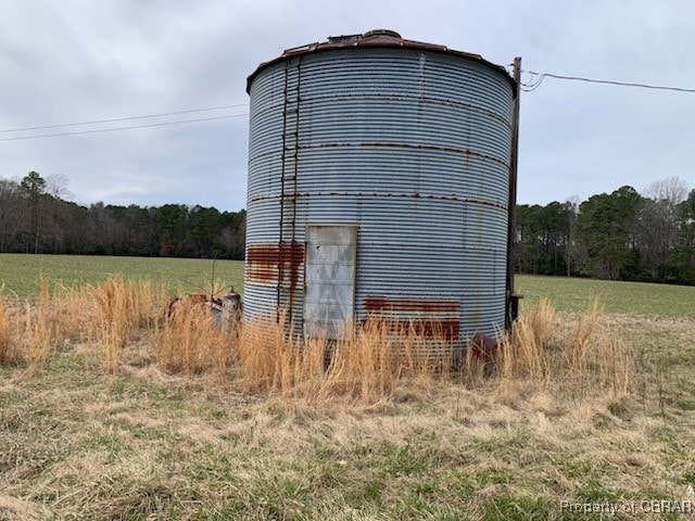 view of pole building with a view of trees