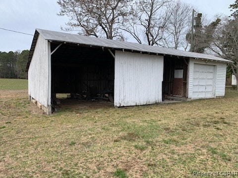 view of pole building with a yard