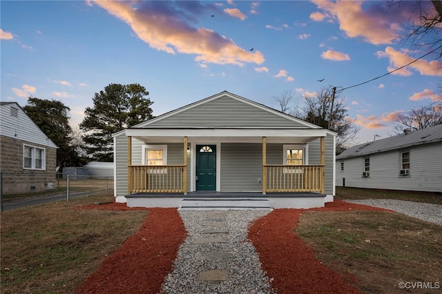 bungalow with a porch and fence