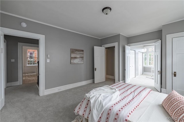 bedroom with baseboards, light carpet, and crown molding