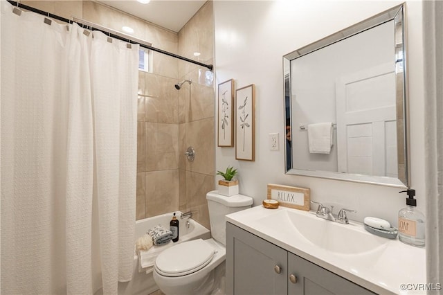 bathroom featuring toilet, shower / bath combo, and vanity