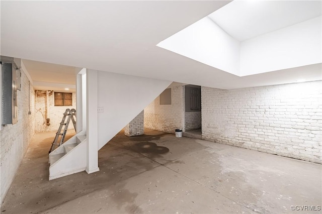 finished basement with brick wall and stairs