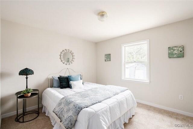 bedroom featuring carpet flooring and baseboards