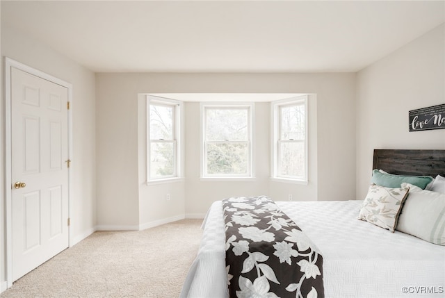 bedroom with carpet flooring and baseboards