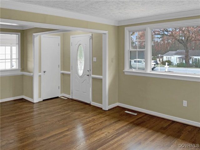 foyer with visible vents, baseboards, dark wood-style flooring, and a textured ceiling