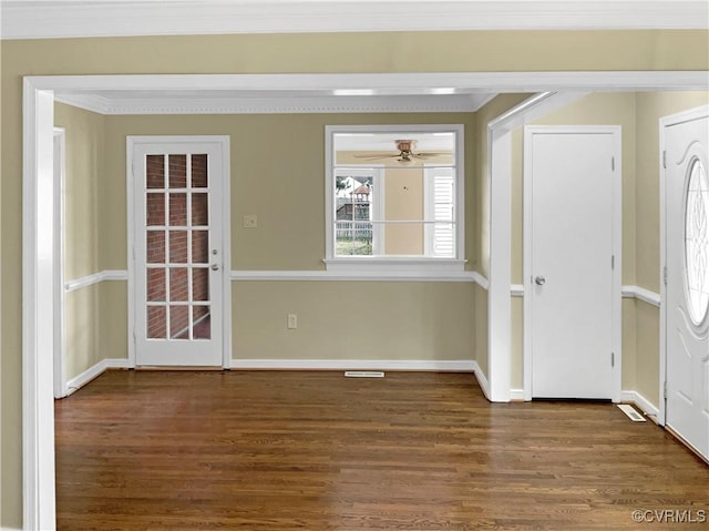 foyer entrance featuring ornamental molding, ceiling fan, baseboards, and wood finished floors