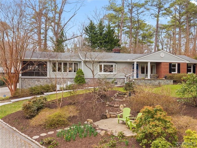 ranch-style house with crawl space, a patio area, a porch, and brick siding