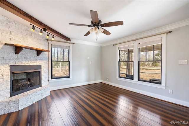 unfurnished living room with a stone fireplace, hardwood / wood-style flooring, crown molding, and baseboards