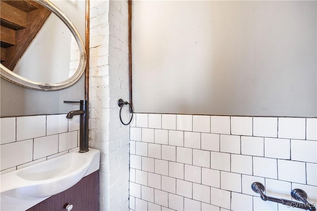 bathroom featuring vanity, tile walls, and wainscoting