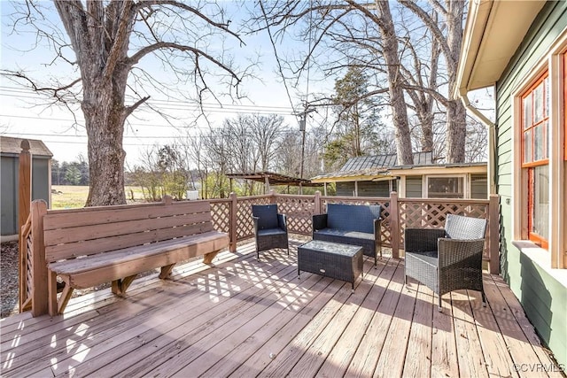 wooden terrace with an outdoor hangout area