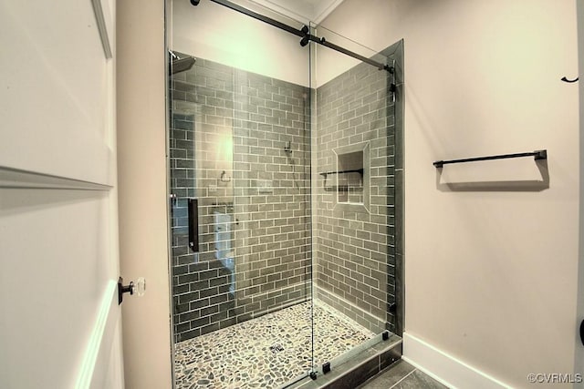 full bathroom featuring baseboards, a stall shower, and tile patterned flooring