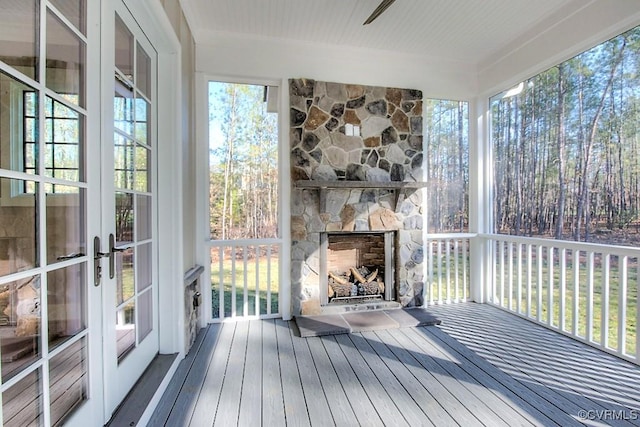 sunroom / solarium with a fireplace