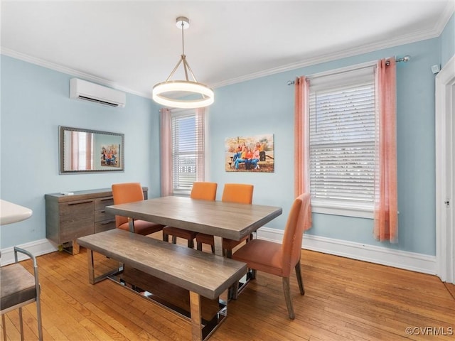 dining room featuring light wood-style flooring, baseboards, an AC wall unit, and ornamental molding