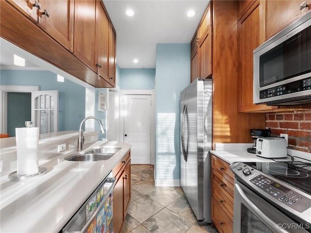 kitchen with a sink, stainless steel appliances, and brown cabinets