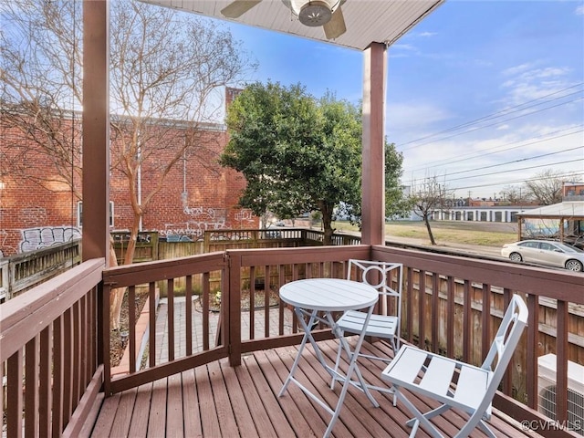 wooden deck featuring ceiling fan