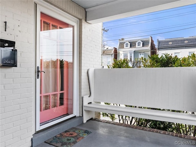 entrance to property featuring brick siding