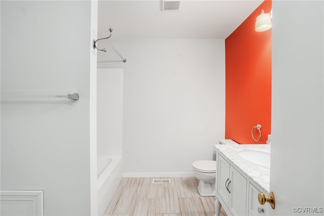 bathroom with visible vents, toilet, vanity, and baseboards