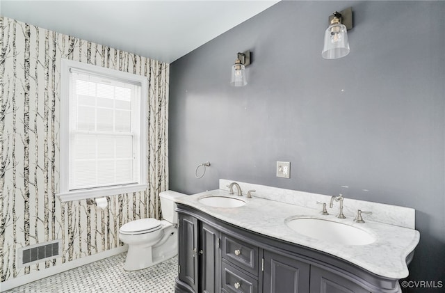 bathroom featuring a wealth of natural light, visible vents, toilet, and a sink