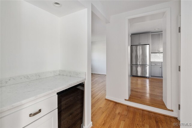 corridor featuring light wood-style floors and beverage cooler